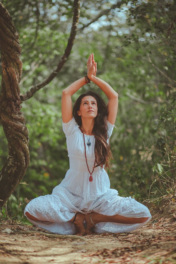 gallery-03 Woman meditating in a peaceful forest setting, embracing calmness and balance.
